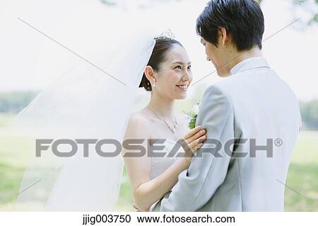 Japanese bride and groom in a city park View Large Photo Image Stock Image - Japanese bride and groom in a city park. Fotosearch
