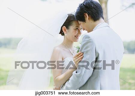 Japanese bride and groom in a city park View Large Photo Image Stock Image - Japanese bride and groom in a city park. Fotosearch