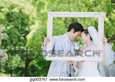 Japanese bride and groom in a city park View Large Photo Image Stock Image - Japanese bride and groom in a city park. Fotosearch