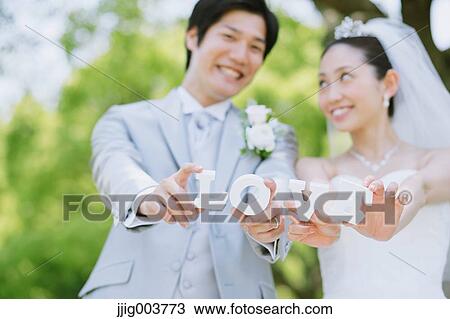 Japanese bride and groom in a city park View Large Photo Image Stock Image - Japanese bride and groom in a city park. Fotosearch