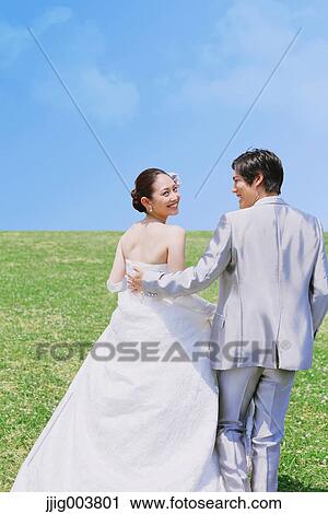 Japanese bride and groom in a city park View Large Photo Image Stock Image - Japanese bride and groom in a city park. Fotosearch