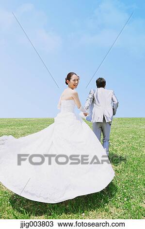 Japanese bride and groom in a city park View Large Photo Image Stock Image - Japanese bride and groom in a city park. Fotosearch