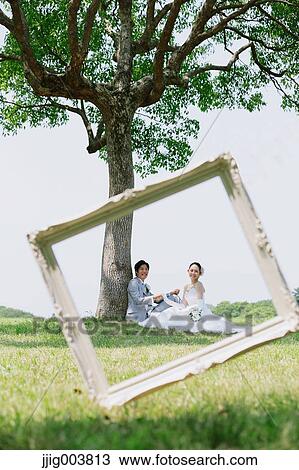 Japanese bride and groom in a city park View Large Photo Image Stock Image - Japanese bride and groom in a city park. Fotosearch