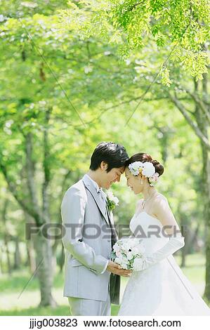 Japanese bride and groom in a city park View Large Photo Image Stock Image - Japanese bride and groom in a city park. Fotosearch