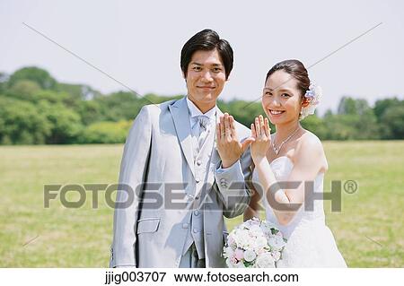 Japanese bride and groom in a city park View Large Photo Image Stock Photo - Japanese bride and groom in a city park. Fotosearch
