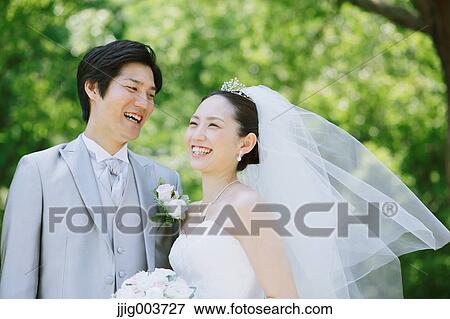 Japanese bride and groom in a city park View Large Photo Image Stock Photo - Japanese bride and groom in a city park. Fotosearch