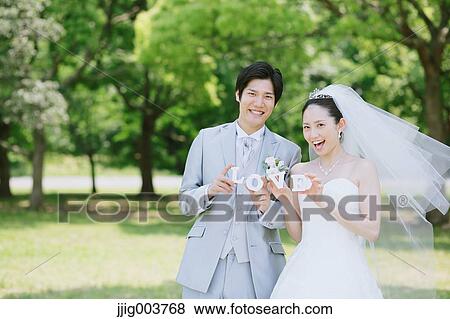 Japanese bride and groom in a city park View Large Photo Image Stock Photo - Japanese bride and groom in a city park. Fotosearch