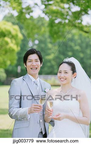 Japanese bride and groom in a city park View Large Photo Image Stock Photo - Japanese bride and groom in a city park. Fotosearch