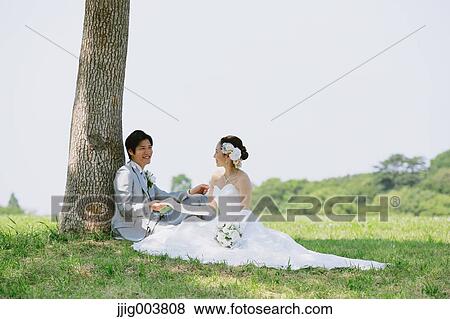 Japanese bride and groom in a city park View Large Photo Image Stock Photo - Japanese bride and groom in a city park. Fotosearch