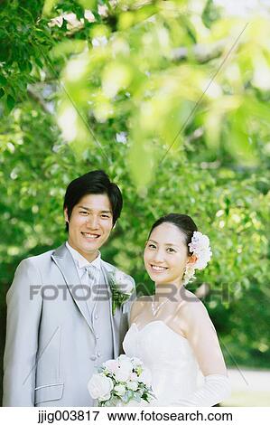 Japanese bride and groom in a city park View Large Photo Image Stock Photo - Japanese bride and groom in a city park. Fotosearch