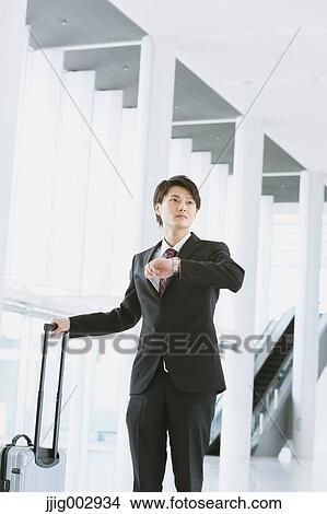 Picture - Japanese businessman at the airport. Fotosearch