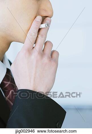 Stock Photograph - Japanese businessman smoking. Fotosearch