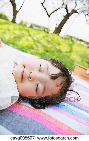 Japanese girl resting under the cherry blossoms View Large Photo Image Stock Photo - Japanese girl resting under the cherry blossoms. Fotosearch