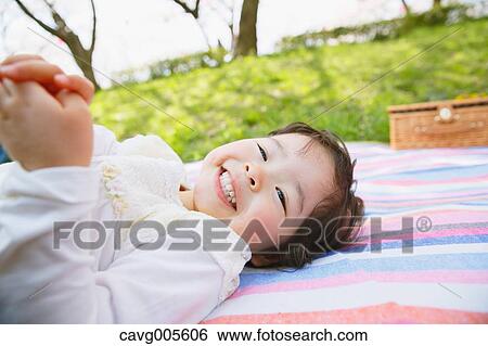 Japanese girl resting under the cherry blossoms View Large Photo Image Stock Photograph - Japanese girl resting under the cherry blossoms. Fotosearch