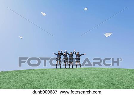 Japanese high school students flying paper planes in a city park View Large Photo Image Stock Photo - Japanese high school students flying paper planes in a city park. Fotosearch
