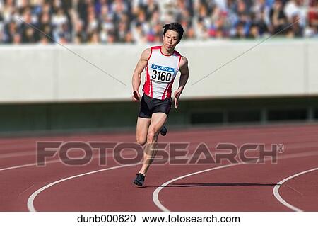 Stock Image - Japanese male sprinter running on track. Fotosearch