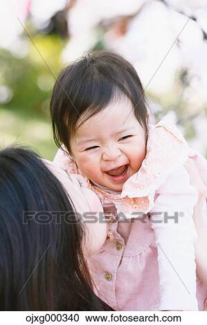 Japanese mom and daughter enjoying the cherry blossoms View Large Photo Image Stock Image - Japanese mom and daughter enjoying the cherry blossoms. Fotosearch