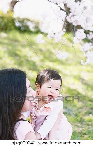 Japanese mom and daughter enjoying the cherry blossoms View Large Photo Image Stock Image - Japanese mom and daughter enjoying the cherry blossoms. Fotosearch