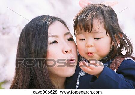 Japanese mom and daughter enjoying the cherry blossoms View Large Photo Image Stock Photo - Japanese mom and daughter enjoying the cherry blossoms. Fotosearch