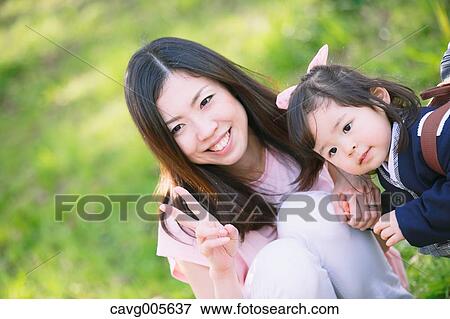 Japanese mom and daughter enjoying the cherry blossoms View Large Photo Image Stock Photo - Japanese mom and daughter enjoying the cherry blossoms. Fotosearch