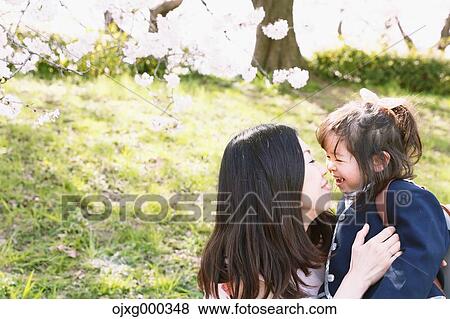 Japanese mom and daughter enjoying the cherry blossoms View Large Photo Image Stock Photo - Japanese mom and daughter enjoying the cherry blossoms. Fotosearch