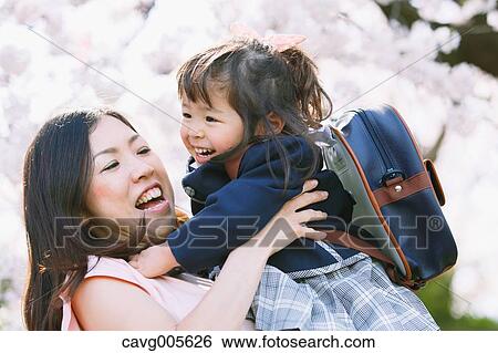 Japanese mom and daughter enjoying the cherry blossoms View Large Photo Image Stock Photograph - Japanese mom and daughter enjoying the cherry blossoms. Fotosearch
