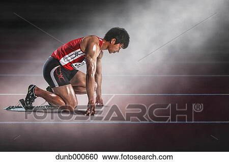 Stock Image - Japanese runner preparing to run. Fotosearch