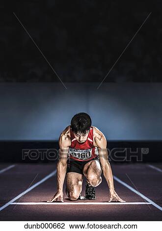 Stock Image - Japanese runner preparing to run. Fotosearch