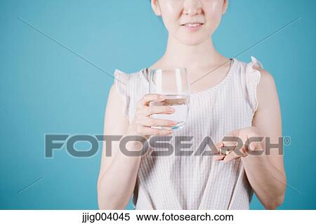 Japanese woman taking pills View Large Photo Image Stock Photography - Japanese woman taking pills. Fotosearch