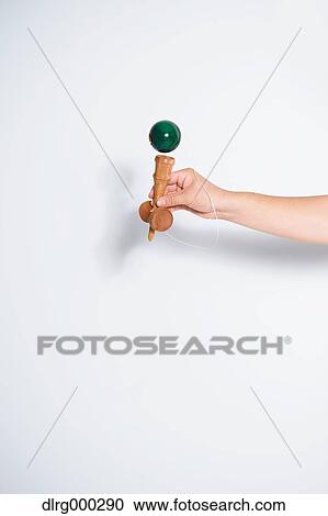 Japanese young man playing with Kendama View Large Photo Image Stock Image - Japanese young man playing with Kendama. Fotosearch