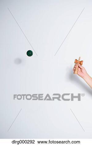 Japanese young man playing with Kendama View Large Photo Image Stock Image - Japanese young man playing with Kendama. Fotosearch