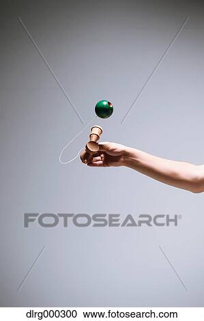 Stock Image - Japanese young man playing with Kendama. Fotosearch