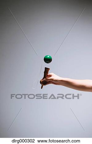 Japanese young man playing with Kendama View Large Photo Image Stock Image - Japanese young man playing with Kendama. Fotosearch