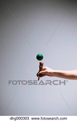 Japanese young man playing with Kendama View Large Photo Image Stock Image - Japanese young man playing with Kendama. Fotosearch