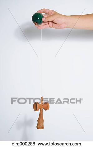 Stock Photo - Japanese young man playing with Kendama. Fotosearch