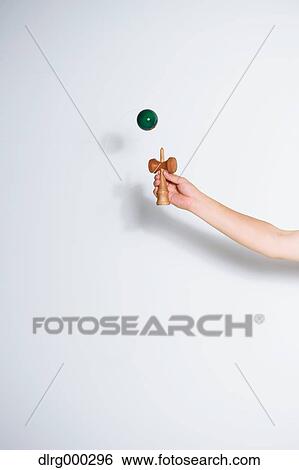 Japanese young man playing with Kendama View Large Photo Image Stock Photograph - Japanese young man playing with Kendama. Fotosearch