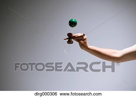Japanese young man playing with Kendama View Large Photo Image Stock Photograph - Japanese young man playing with Kendama. Fotosearch