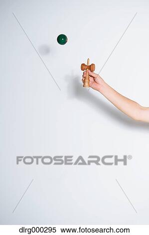 Stock Photography - Japanese young man playing with Kendama. Fotosearch
