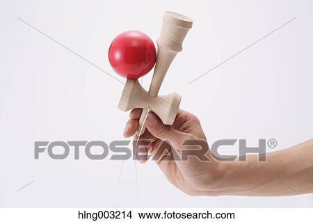 Picture - Man playing with Japanese traditional Kendama game. Fotosearch