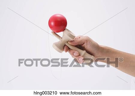 Man playing with Japanese traditional Kendama game View Large Photo Image Stock Image - Man playing with Japanese traditional Kendama game. Fotosearch
