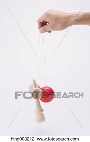 Man playing with Japanese traditional Kendama game View Large Photo Image Stock Image - Man playing with Japanese traditional Kendama game. Fotosearch