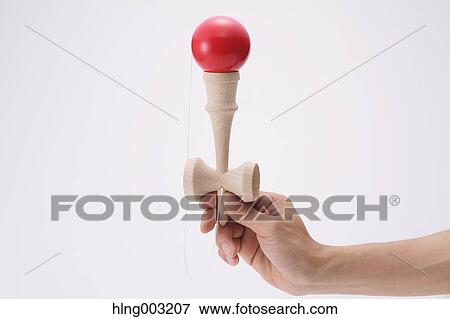Man playing with Japanese traditional Kendama game View Large Photo Image Stock Photo - Man playing with Japanese traditional Kendama game. Fotosearch