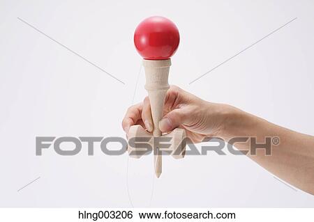 Man playing with Japanese traditional Kendama game View Large Photo Image Stock Photograph - Man playing with Japanese traditional Kendama game. Fotosearch