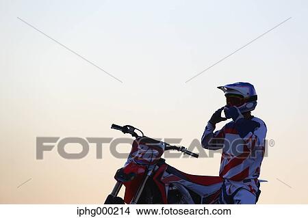 Picture - Motocross biker on dirt track. Fotosearch