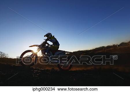 Picture - Motocross biker on dirt track. Fotosearch