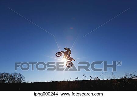 Picture - Motocross biker on dirt track. Fotosearch