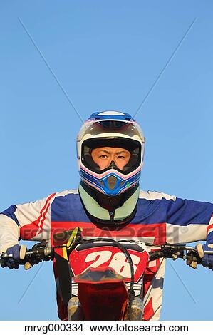 Picture - Motocross biker on dirt track. Fotosearch