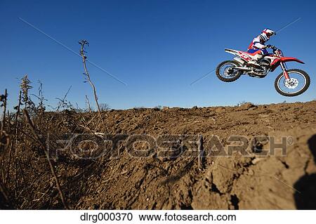 Motocross biker on dirt track View Large Photo Image Stock Image - Motocross biker on dirt track. Fotosearch