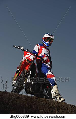 Motocross biker on dirt track View Large Photo Image Stock Photo - Motocross biker on dirt track. Fotosearch