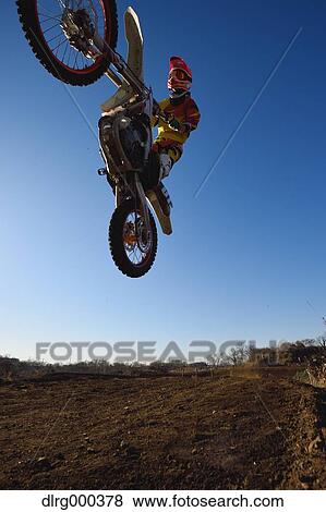 Motocross biker on dirt track View Large Photo Image Stock Photo - Motocross biker on dirt track. Fotosearch